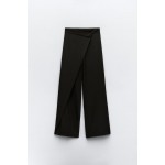 Pants with a high front wrap waist and snap button. Wide leg. Side hidden in-seam zip closure.