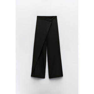 Pants with a high front wrap waist and snap button. Wide leg. Side hidden in-seam zip closure.