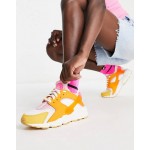 Nike Air Huarache trainers in white and hype pink solar mix